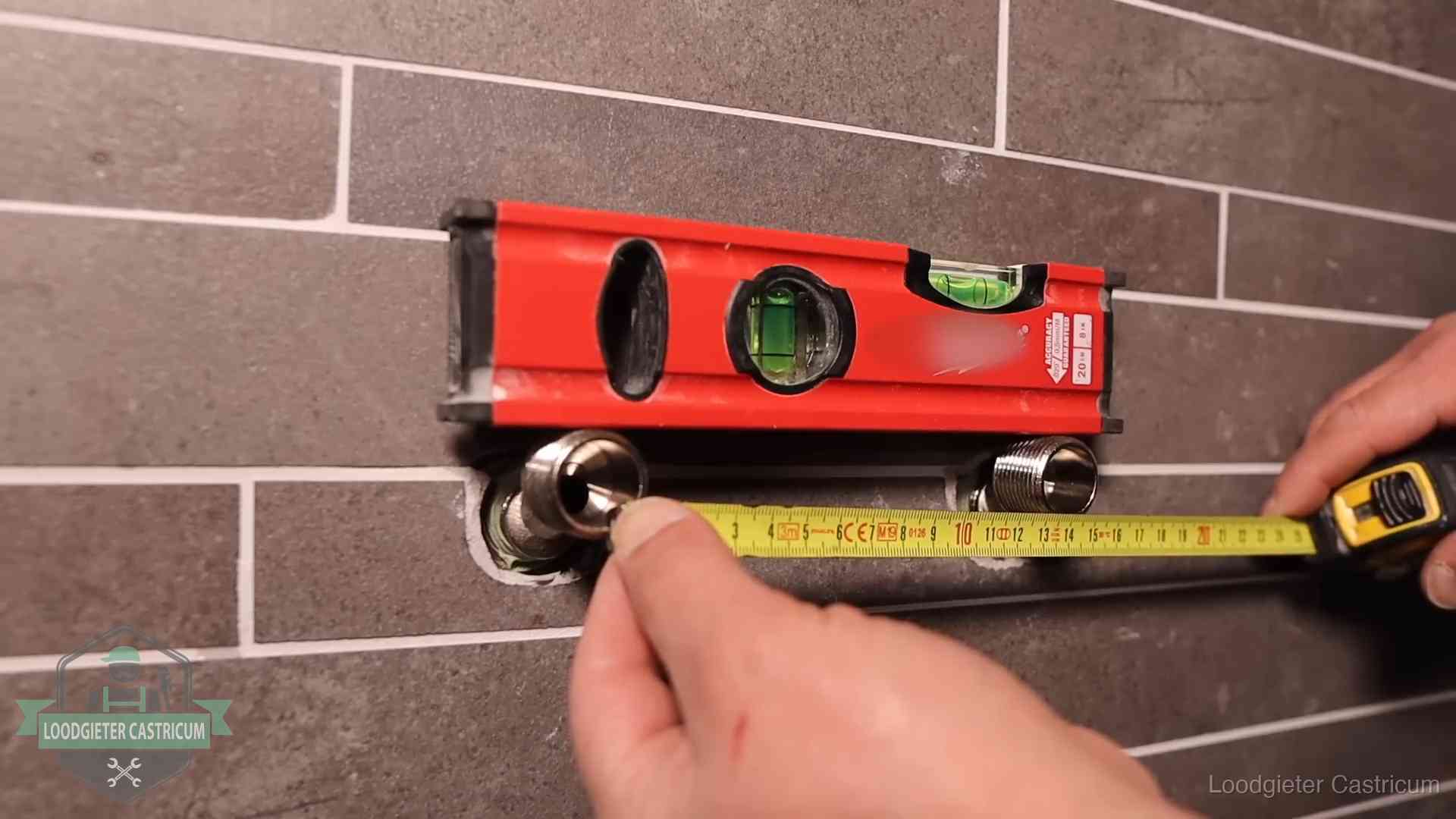 Waterpas en duimstok bij kraan-aansluitpunten in een badkamer in Castricum